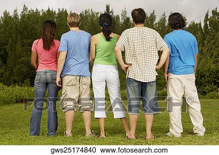 Rear view of five people standing side by side View Large Photo Image Stock Image - Rear view of five people standing side by side. Fotosearch