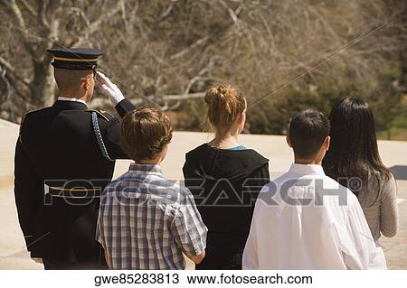 Rear view of four people standing with an honor guard View Large Photo Image Stock Image - Rear view of four people standing with an honor guard. Fotosearch