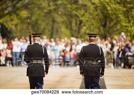 Rear view of two honor guards in front of a large group of people View Large Photo Image Stock Photo - Rear view of two honor guards in front of a large group of people. Fotosearch