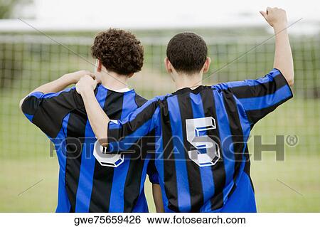 Stock Photograph - Rear view of two soccer players. Fotosearch