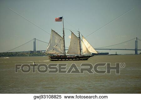 Sailboat near a suspension bridge, Brooklyn Bridge, Manhattan, New York City, New York State, USA View Large Photo Image Stock Photography - Sailboat near a suspension bridge, Brooklyn Bridge, Manhattan, New York City, New York State, USA. Fotosearch