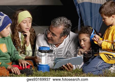 Senior man and his four grandchildren near a tent View Large Photo Image Stock Photo - Senior man and his four grandchildren near a tent. Fotosearch