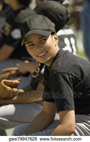 Stock Photo - Side profile of a baseball player smiling. Fotosearch
