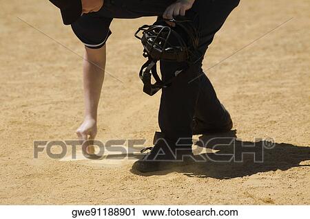 Side profile of a baseball umpire marking a baseball field View Large Photo Image Stock Image - Side profile of a baseball umpire marking a baseball field. Fotosearch