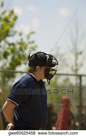 Side profile of a baseball umpire wearing a helmet View Large Photo Image Stock Photo - Side profile of a baseball umpire wearing a helmet. Fotosearch