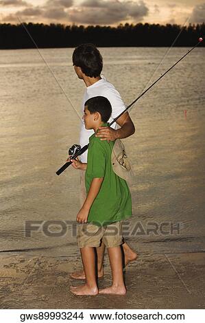 Side profile of a father and his son fishing View Large Photo Image Picture - Side profile of a father and his son fishing. Fotosearch