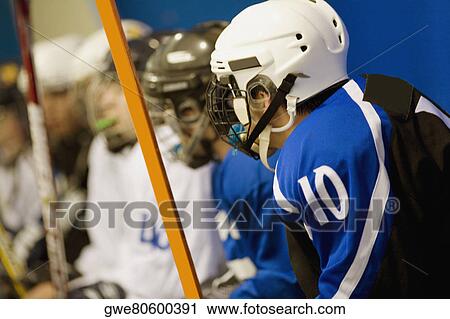 Stock Image - Side profile of a group of ice hockey players in uniforms. Fotosearch