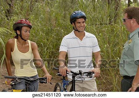 Side profile of a mature man talking to a mid adult man and a young woman View Large Photo Image Stock Image - Side profile of a mature man talking to a mid adult man and a young woman. Fotosearch