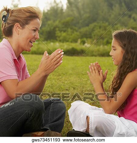 Side profile of a mature woman playing with her daughter in the park View Large Photo Image Stock Image - Side profile of a mature woman playing with her daughter in the park. Fotosearch