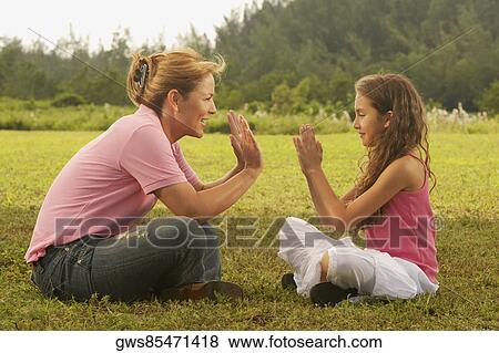 Side profile of a mature woman playing with her daughter in the park View Large Photo Image Stock Photo - Side profile of a mature woman playing with her daughter in the park. Fotosearch