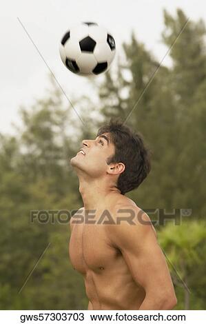 Side profile of a mid adult man playing with a soccer ball View Large Photo Image Stock Image - Side profile of a mid adult man playing with a soccer ball. Fotosearch