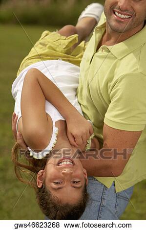 Side profile of a mid adult man carrying his daughter View Large Photo Image Stock Photo - Side profile of a mid adult man carrying his daughter. Fotosearch