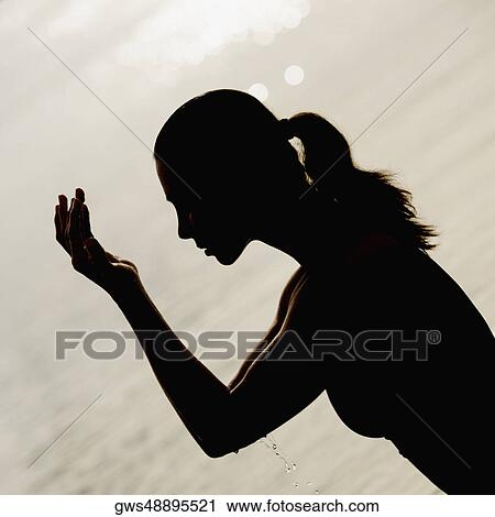 Side profile of a mid adult woman washing her face with water View Large Photo Image Stock Image - Side profile of a mid adult woman washing her face with water. Fotosearch