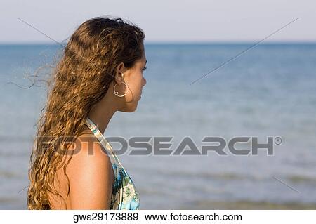 Side profile of a teenage girl on the beach View Large Photo Image Stock Photo - Side profile of a teenage girl on the beach. Fotosearch