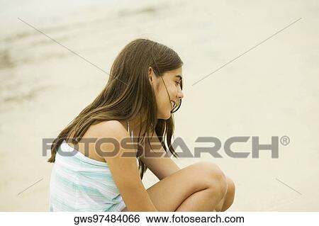 Stock Photograph - Side profile of a teenage girl smiling. Fotosearch