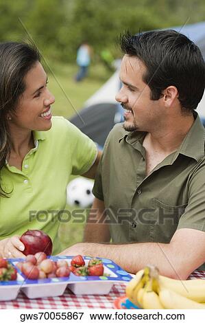 Side profile of a young couple looking at each other View Large Photo Image Stock Photo - Side profile of a young couple looking at each other. Fotosearch
