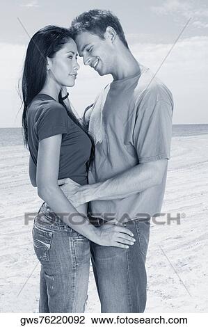 Side profile of a young couple embracing each other View Large Photo Image Stock Image - Side profile of a young couple embracing each other. Fotosearch