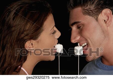 Side profile of a young man and a teenage girl eating marshmallows View Large Photo Image Stock Photography - Side profile of a young man and a teenage girl eating marshmallows. Fotosearch
