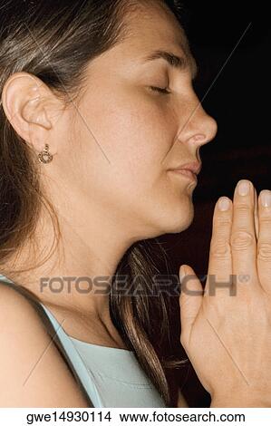 Side profile of a young woman meditating View Large Photo Image Picture - Side profile of a young woman meditating. Fotosearch