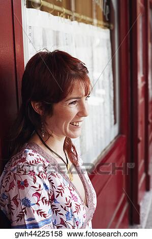 Side profile of a young woman smiling View Large Photo Image Stock Photo - Side profile of a young woman smiling . Fotosearch