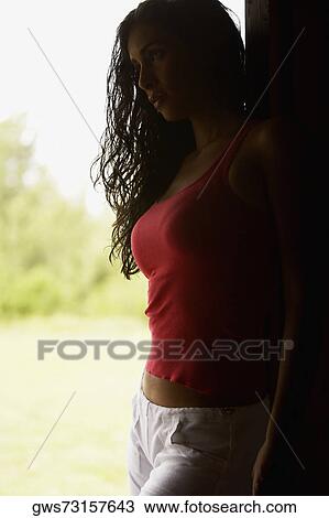 Side profile of a young woman standing View Large Photo Image Stock Image - Side profile of a young woman standing. Fotosearch
