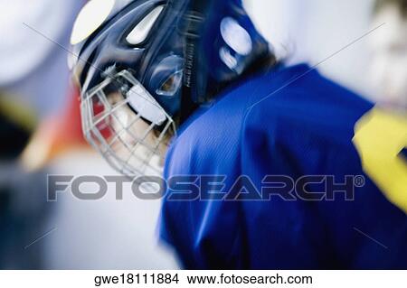 Picture - Side profile of an ice hockey player wearing a helmet. Fotosearch