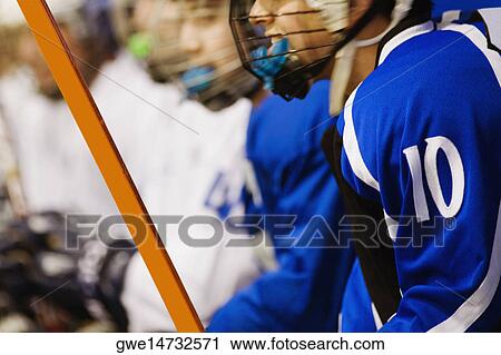 Side profile of an ice hockey player holding an ice hockey stick View Large Photo Image Stock Image - Side profile of an ice hockey player holding an ice hockey stick. Fotosearch