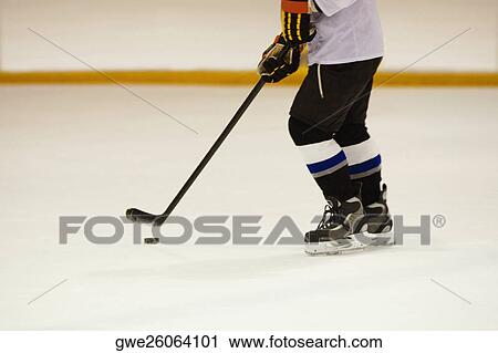 Side profile of an ice hockey player playing ice hockey View Large Photo Image Stock Image - Side profile of an ice hockey player playing ice hockey. Fotosearch