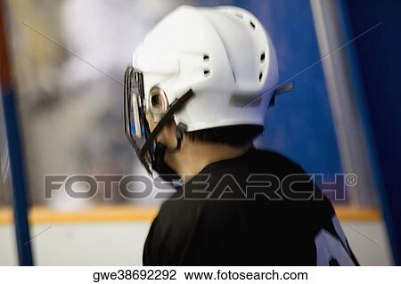 Side profile of an ice hockey player wearing a helmet View Large Photo Image Stock Image - Side profile of an ice hockey player wearing a helmet. Fotosearch