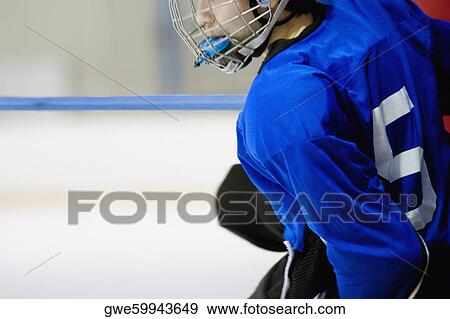 Side profile of an ice hockey player wearing a helmet View Large Photo Image Stock Photo - Side profile of an ice hockey player wearing a helmet. Fotosearch