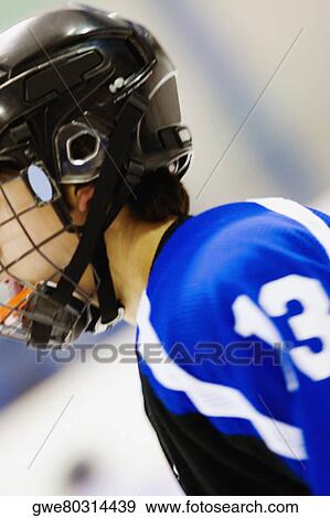 Side profile of an ice hockey player wearing a helmet View Large Photo Image Stock Photo - Side profile of an ice hockey player wearing a helmet. Fotosearch