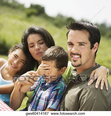 Stock Photo - Side profile of parents and their two children. Fotosearch