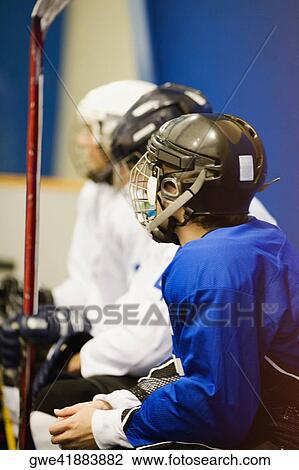Side profile of three ice hockey players wearing helmets View Large Photo Image Stock Image - Side profile of three ice hockey players wearing helmets. Fotosearch