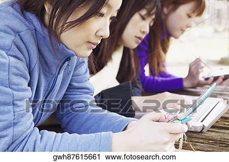 Stock Image - Side profile of three young women . Fotosearch