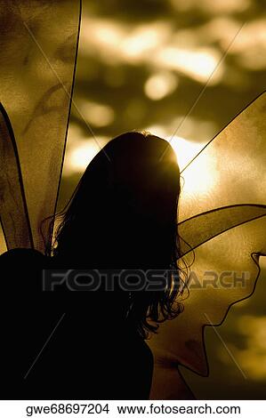 Picture - Silhouette of a lesbian woman in a fairy costume. Fotosearch