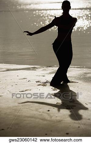 Silhouette of a mid adult woman exercising on the beach View Large Photo Image Stock Image - Silhouette of a mid adult woman exercising on the beach. Fotosearch