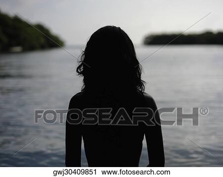 Silhouette of a young woman by the sea View Large Photo Image Stock Image - Silhouette of a young woman by the sea. Fotosearch