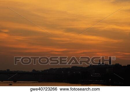 Silhouette of buildings at dusk View Large Photo Image Stock Photograph - Silhouette of buildings at dusk. Fotosearch