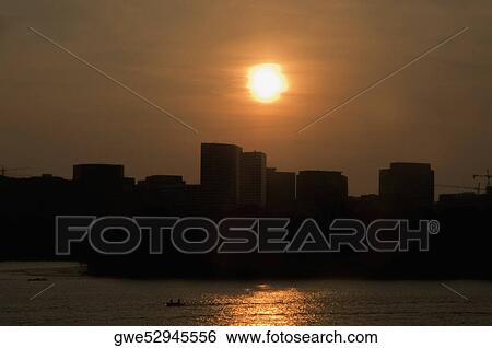 Stock Photograph - Silhouette of buildings at dusk. Fotosearch