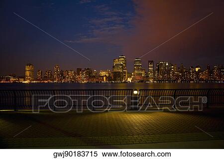 Skyscrapers at the waterfront lit up at night, New York City, New York State, USA View Large Photo Image Stock Photography - Skyscrapers at the waterfront lit up at night, New York City, New York State, USA. Fotosearch