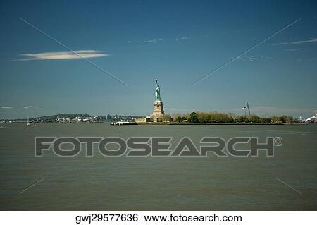 Statue at the waterfront, Statue Of liberty, Liberty Island, New York City, New York State, USA View Large Photo Image Stock Photograph - Statue at the waterfront, Statue Of liberty, Liberty Island, New York City, New York State, USA. Fotosearch