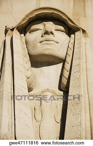 Stock Photograph - Statue carved on a wall. Fotosearch