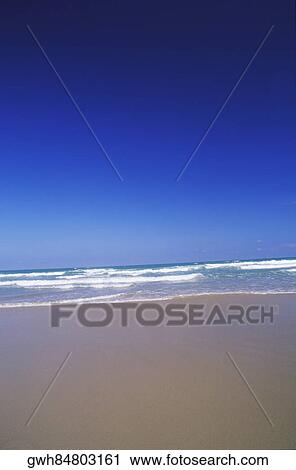 Stock Image - Surfs on the beach, Texas, USA. Fotosearch
