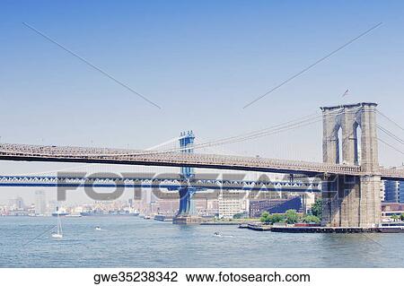 Stock Image - Suspension bridge across a river, Brooklyn Bridge, Manhattan, New York City, New York State, USA. Fotosearch