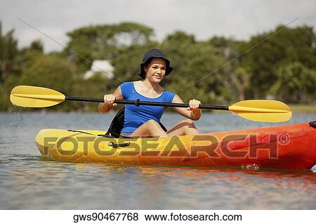 Stock Photo - Teenage girl kayaking. Fotosearch