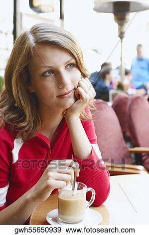 Stock Photo - Teenage girl sitting in a restaurant . Fotosearch