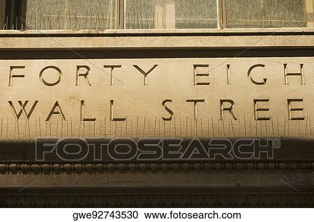 Stock Image - Text engraved on a wall, Wall Street, Manhattan, New York City, New York State, USA. Fotosearch