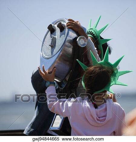 Three people standing near coin-operated binoculars, New York City, New York State, USA View Large Photo Image Stock Photography - Three people standing near coin-operated binoculars, New York City, New York State, USA. Fotosearch