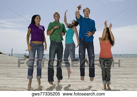 Three young women and two young men jumping on the beach View Large Photo Image Stock Photography - Three young women and two young men jumping on the beach. Fotosearch