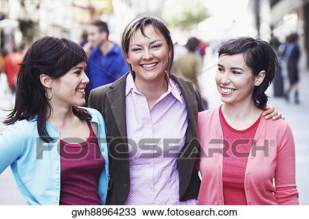 Three young women standing on the street View Large Photo Image Stock Image - Three young women standing on the street . Fotosearch